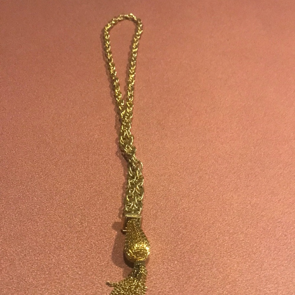 Bold goldtone over the head necklace had a very interesting pendant